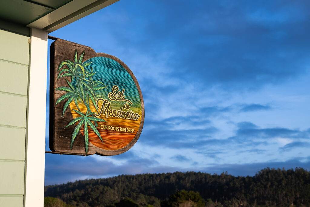 Sol de Mendocino wooden sign against a blue sky.