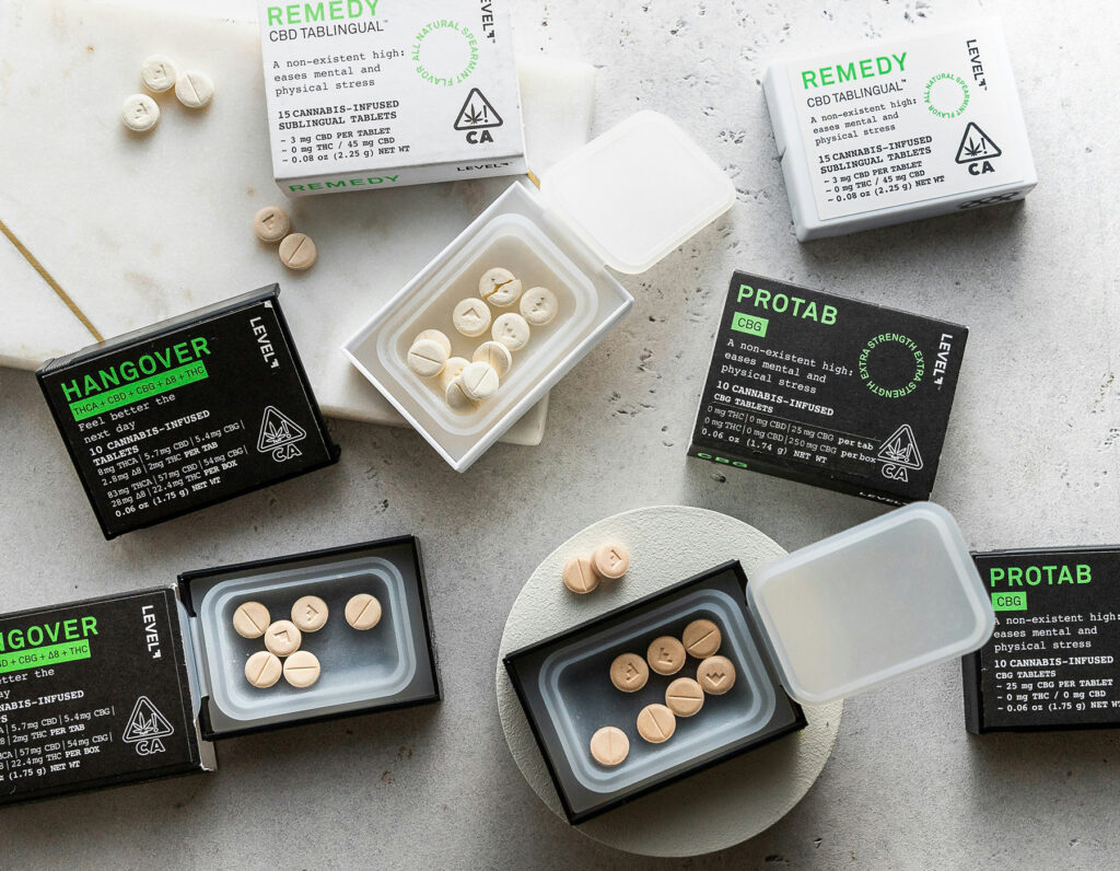 LEVEL tablets are open and spread out on a table. These are an example of products containing rare or alternative cannabinoids in various ratios for tailored effects. Available at Sol de Mendocino.