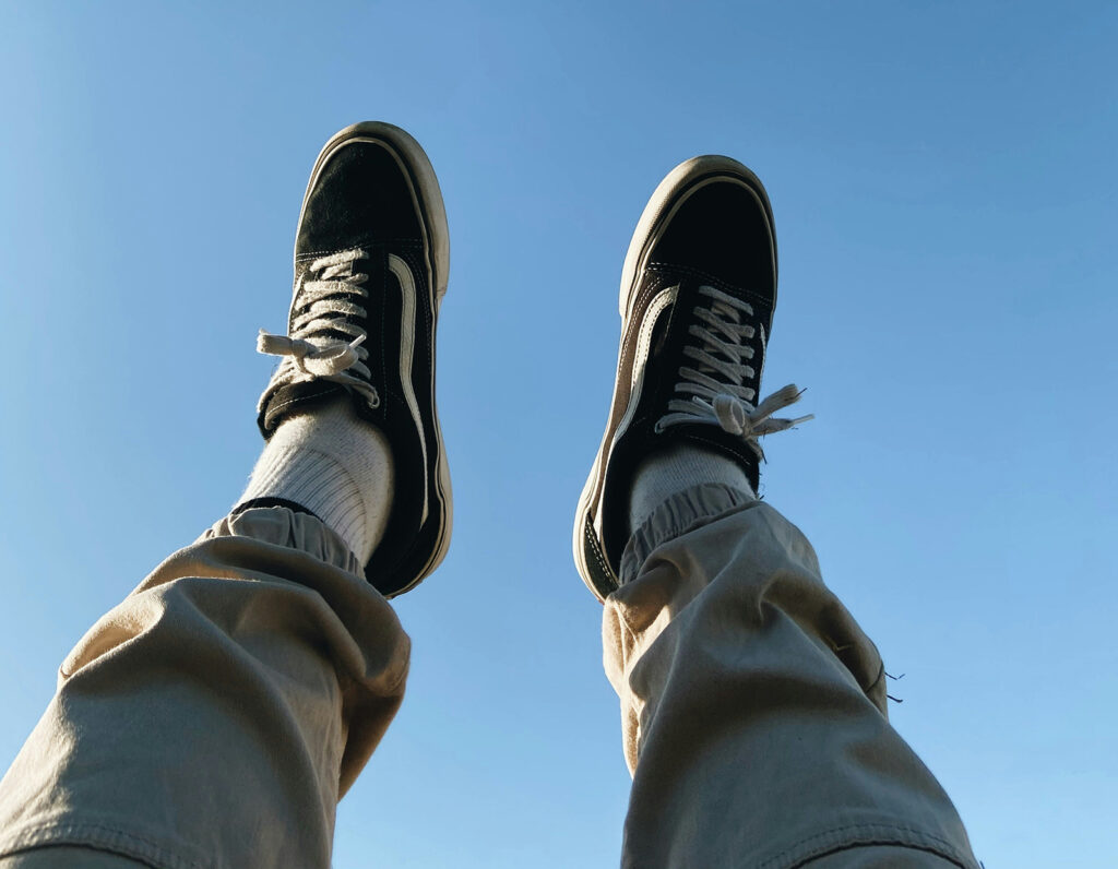 What to Do if You Get Too High - Regulating Your Cannabis Experience - two feet up in the air with a blue sky behind them.